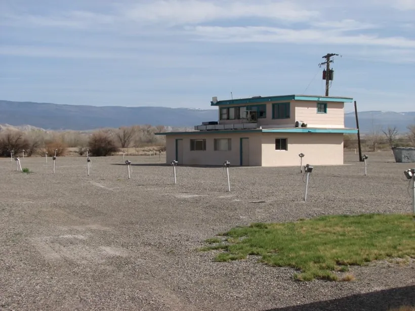 The Tru-Vu screen tower, control building, and in-car speaker poles on the lot