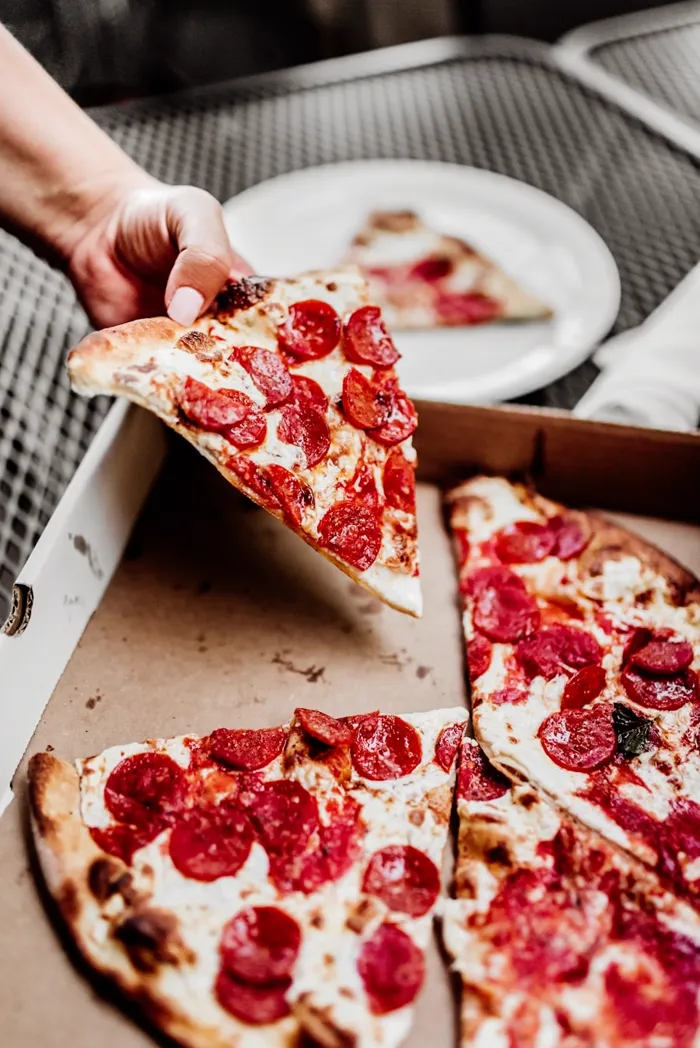 Hand-pressed pepperoni pizza slice